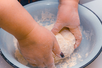 Fototapeta premium Mix the dough with your hands in a bowl