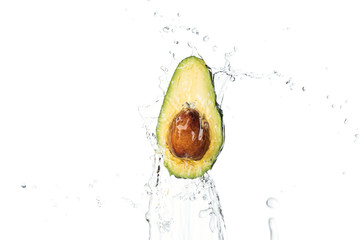 ripe nutritious avocado half with seed and transparent water splash with drops isolated on white