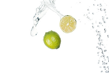 green fresh limes with clear water splash isolated on white