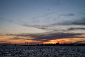 Fototapeta na wymiar Shipping port silhouette at sunset
