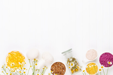Spa still life with aromatherapy chamomile, herbal oil, soap, sea salt.
