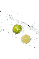 green fresh whole lime and half with clear water splash and drops isolated on white