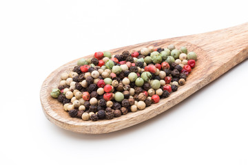 Pepper mix seed on spoon on white background.