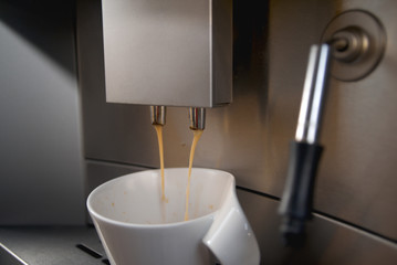 fresh coffee pouring into a cup