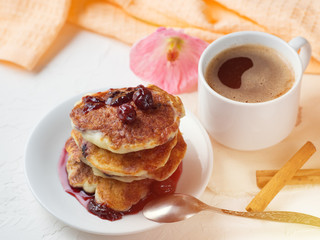 White coffee Cup and pancakes with cherry jam