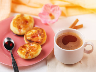 White Cup of coffee and cheesecake pancake in a plate