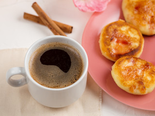 White Cup of coffee and cheesecake pancake in a plate