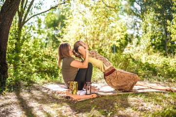 Master massage therapist applies her massage skills on her client in nature.