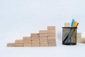 Wood block stacking as step stair on wooden table. Business concept for growth success process with color marker case
