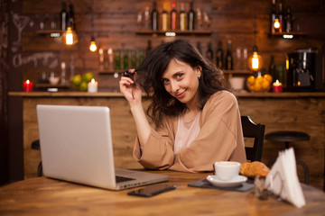 Portrait of caucasian woman smiling at the camera in a hispter coffee shop