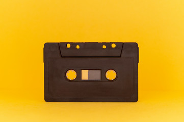 Obraz premium black audio cassette on orange background