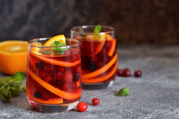 Hot cranberry tea with orange, mint and spices.