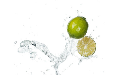 green fresh limes with clear water splash and drops isolated on white