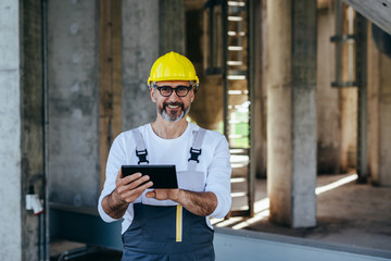 construction worker using tablet on construction site