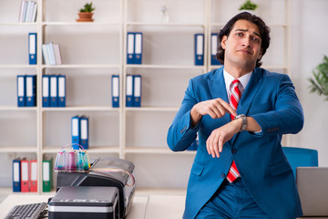 Young employee making copies at copying machine 