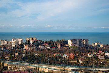 Obraz premium View from the window to the sea, the road and part of the city. In the summer, in Sunny weather with a few clouds.