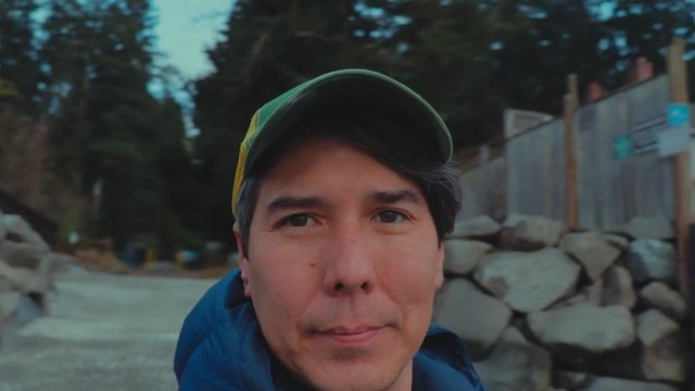 SloMo - Headshot of Man Spinning on Cold Rocky Beach on Bainbridge Island, Washington.