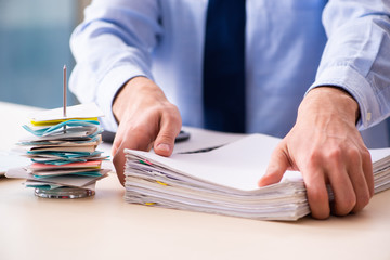 Young male employee in budget planning concept 