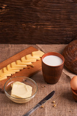 Assorted dairy products milk, cheese, butter rustic still life on table