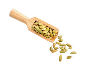 green cardamon isolated in wood scoop on white background