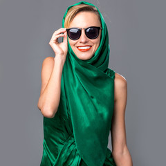 Portrait of a beautiful sexy blonde in green dress, sunglasses and head scarf. Summer, spring fashion woman