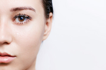 Beautiful young woman with wet healthy perfect glow clean skin. Portrait of model with brown eyes,...