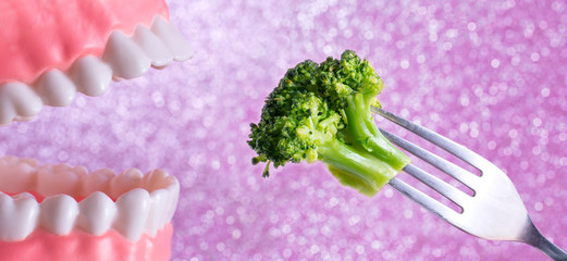 Open mouth, teeth and broccoli – one should eat healthy