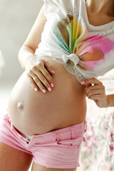 Pregnancy, close-up. Concept of happy pregnancy and motherhood
