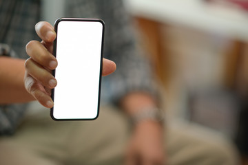 Man's hand shows mobile smartphone with blank white screen