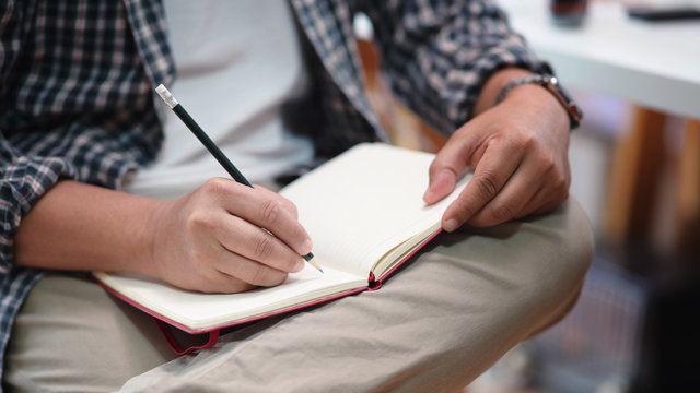 Man taking notes on a notebook