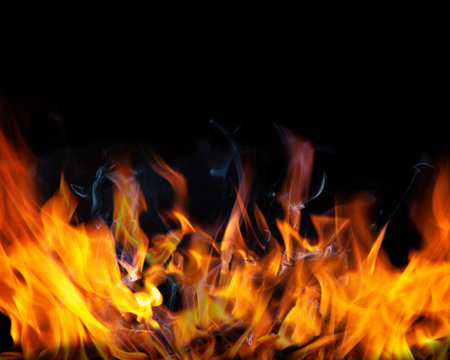 Fire flames and Smoke on black color background . Image of burning fire for decorative special effect .