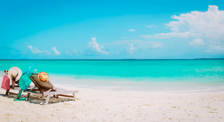 Fototapeta na wymiar Two beach chairs on tropical vacation, family at sea