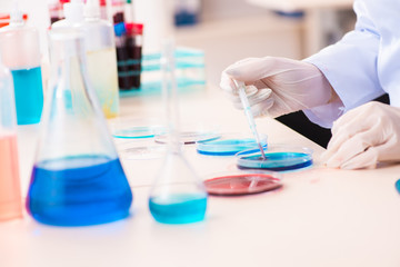 Young female chemist working in the lab 