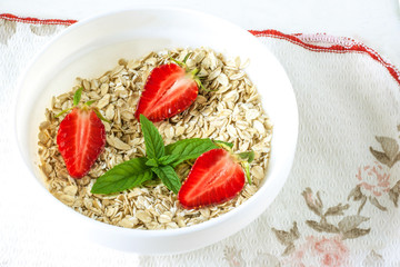 A plate with strawberries and oatmeal.Healthy food.