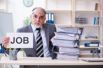 Aged male employee unhappy with excessive work 