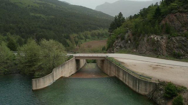 Aerial push over bridge at Lake Doxa countryside in Greece 4k
