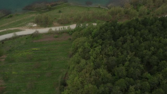 Top down aerial flying over countryside of Greece, revealing Lake Doxa 4k