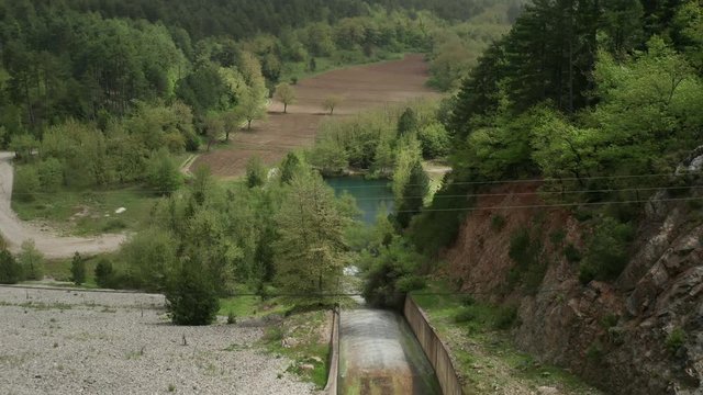Aerial pullback from reservoir at Lake Doxa, revealing shot of beautiful Greece countryside