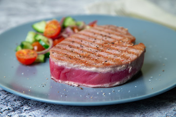 Grilled tuna steak with vegetables. Selective focus, close-up.