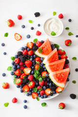 fruit and berry platter over white. blueberry, strawberry, raspberry, blackberry, watermelon
