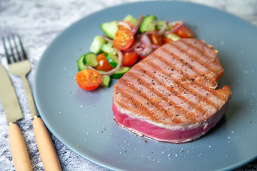 Grilled tuna steak with vegetables. Selective focus, close-up.