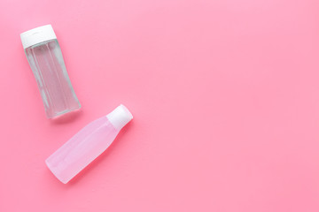 facial tonic and lotion for face care on pink background top view mock up