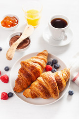 Continental breakfast with croissant, jam, chocolate spread and coffee