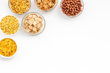 cereals, oatflakes and cornflakes for healthy breakfast on white background top view mock up