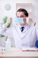 Young male chemist experimenting in lab