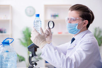 Young male chemist experimenting in lab