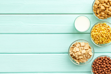 Cereals and flakes from corn and oat on mint wooden background top view mockup