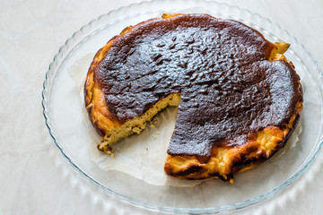 San Sebastian Cheesecake on Wooden surface / Creamy Plain New York Style.