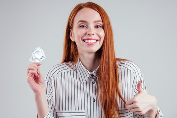 picture of young redhead be lost in thought businesswoman in striped shirt with pack of condom and...