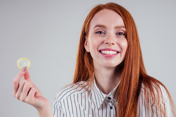 picture of young redhead be lost in thought businesswoman in striped shirt with pack of condom and...